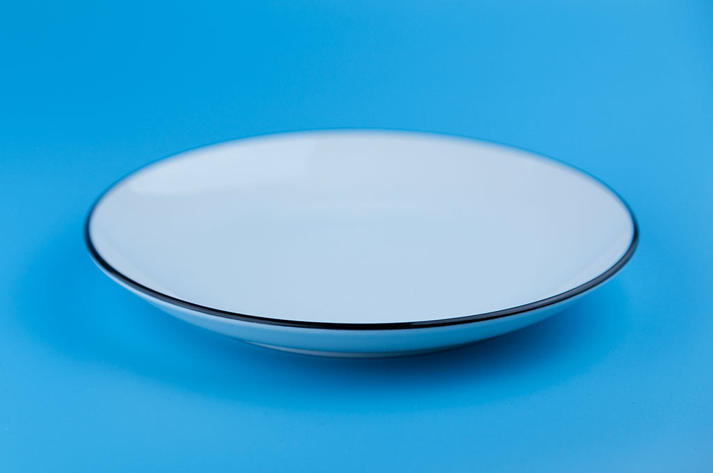 empty white plate against blue background
