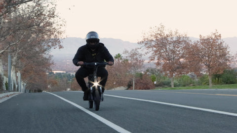 EMOVE RoadRunner electric scooter with man riding uphill