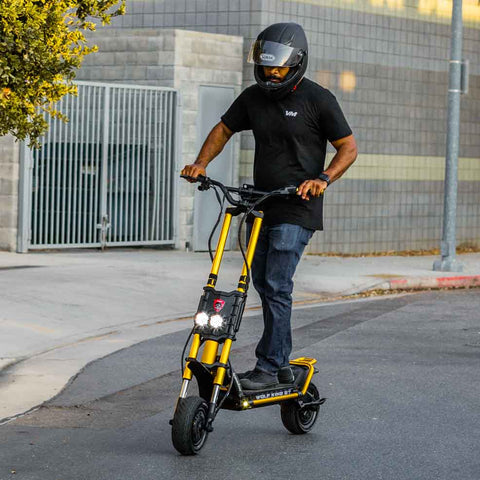 Man riding Wolf King GT electric scooter