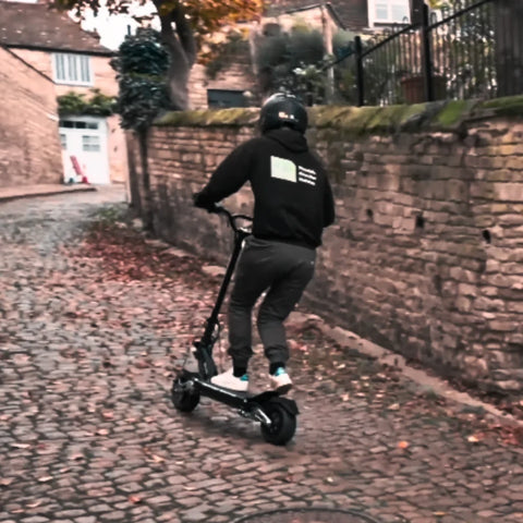 Riding an electric scooter up the slope