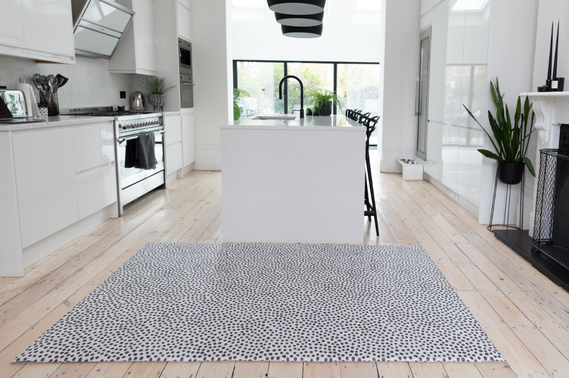 Minimal kitchen with luxe totter and tumble mat for play