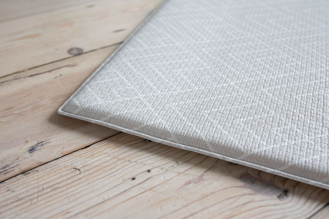 close up of dove grey roamer playmat with vintage chevron design 