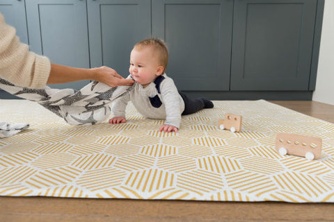 Happy baby tummy time on a luxury Totter + Tumble playmat