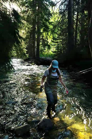 Fly Fishing Woman Angler wading in mountain river