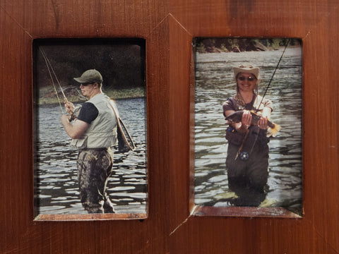 Man holding a rod and woman holding a cut throat trout fish, fly fishing in a river
