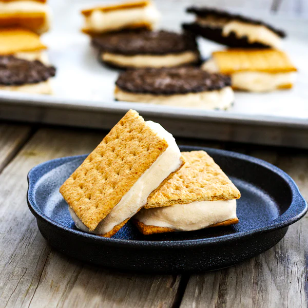 two coffee ice cream sandwiches in a plate on a wooden table