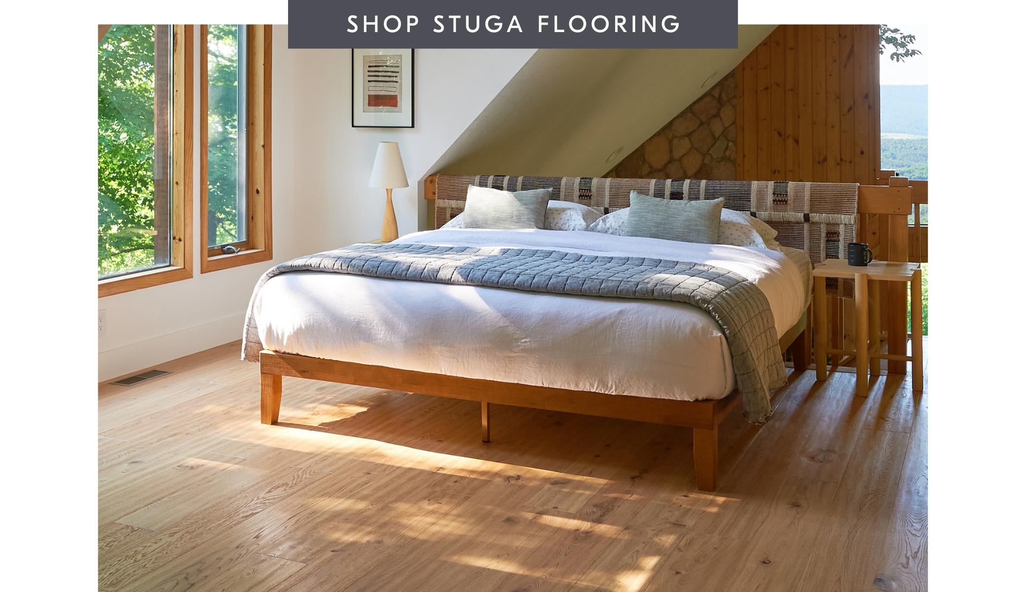 Text reading shop Stuga flooring with an image of a bedroom with natural Scandinavian flooring