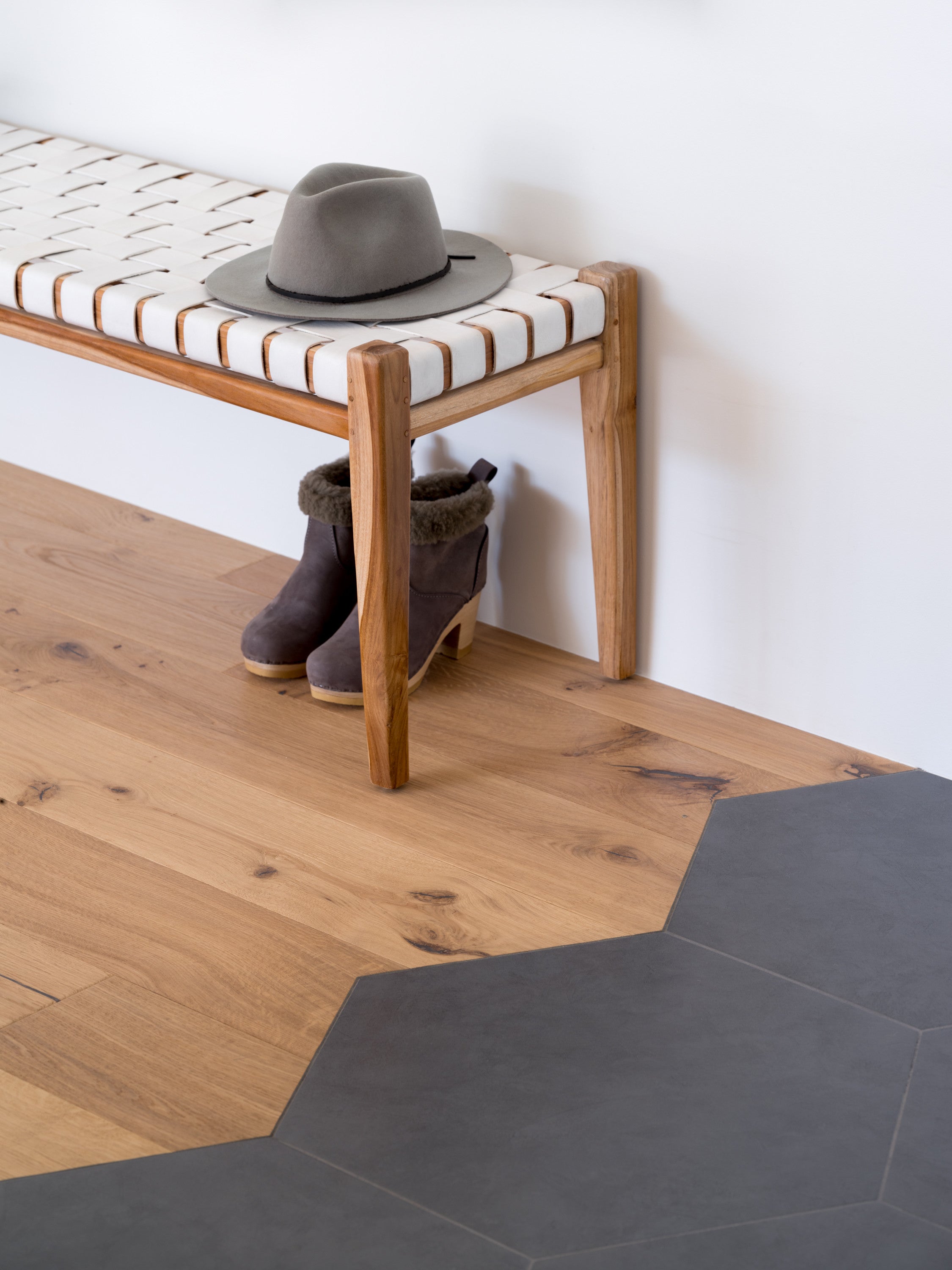 Shell natural white oak flooring by Stuga with transition to black hexagon tile