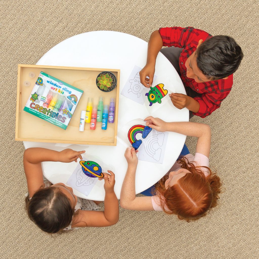 Kids painting a rainbow, monster and a planet using Creatibles DIY Window Cling Art Kit