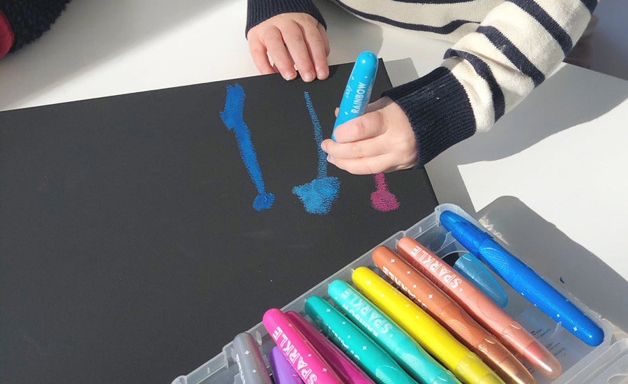 Drawing firework lines with rainbow sparkle watercolor gel crayons