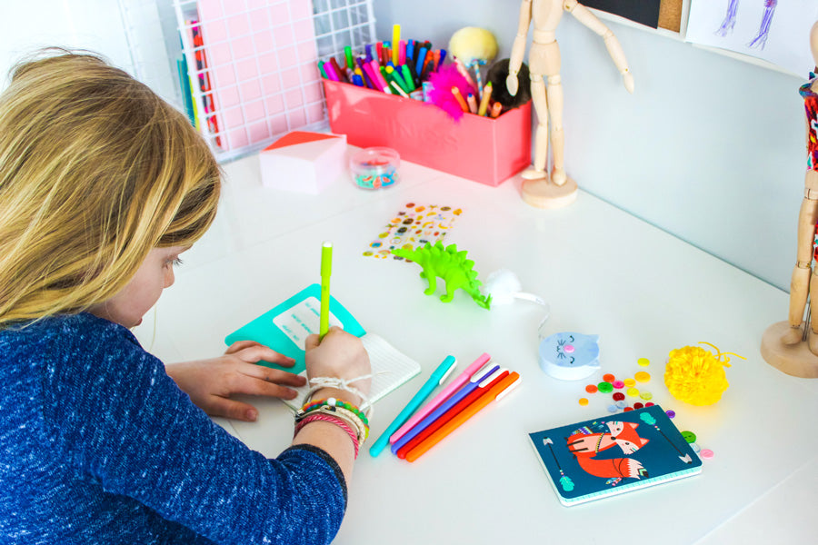 Writing in pocket pal journals in a kids art space