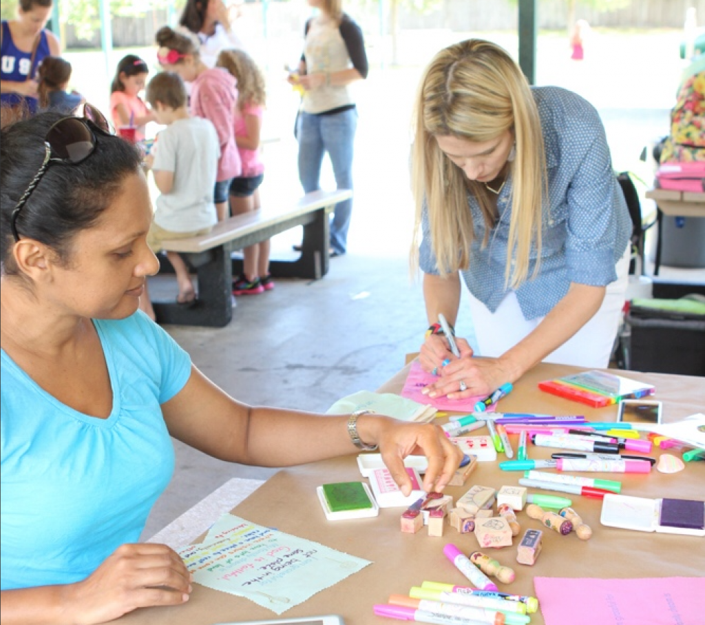 Adults outside during arts & crafts time using a coloring set