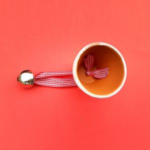 View inside of a pot that has a ribbon and bell