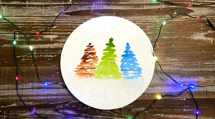 brown, green and blue trees on white circular paper on brown surface with lights