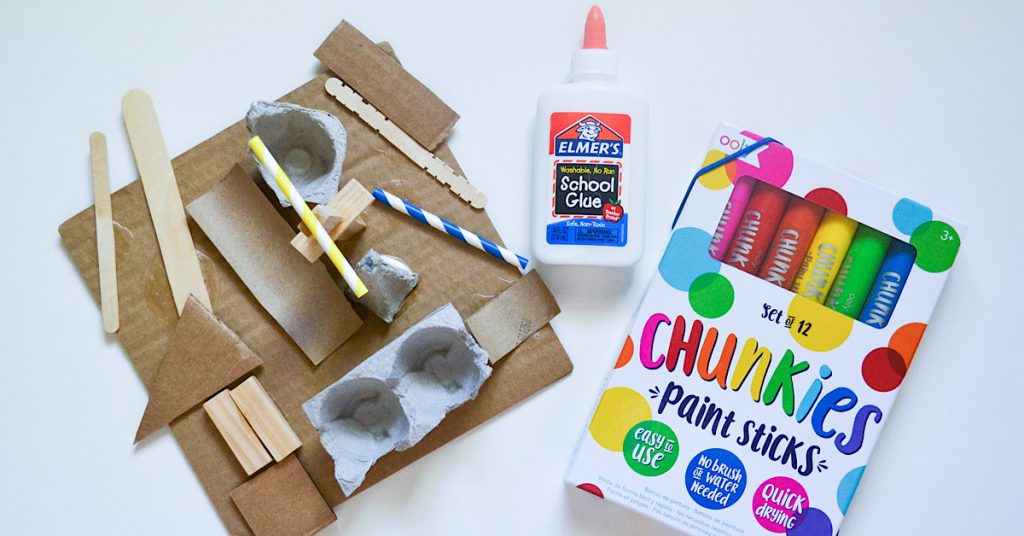 recycled materials on cardboard and chunkies paint sticks on white surface