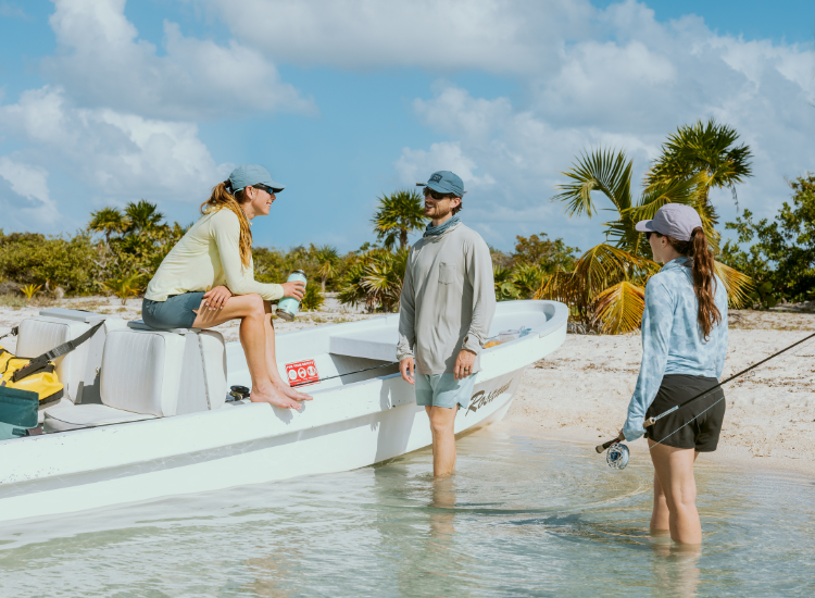 Friends hanging out on their boat while fishing in the Bahamas