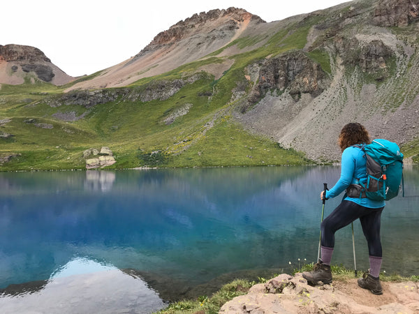 A woman looking out on Ice Lake in San Juan National Forest, Colorado