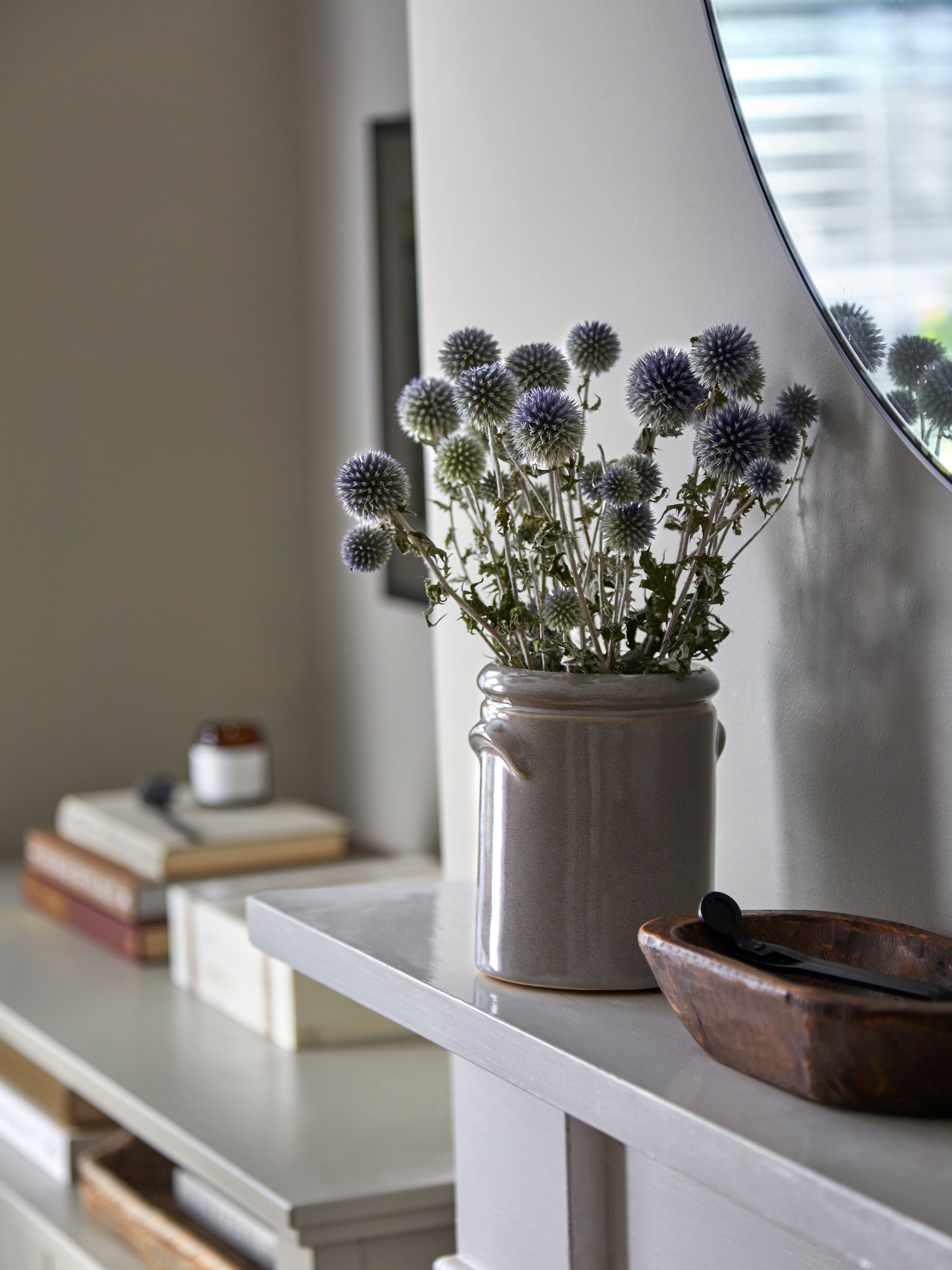 Hudson Home fireplace with vase and dried echinops