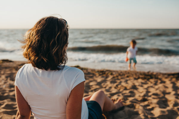 mother watching child at the beach