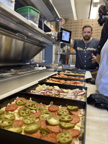 pan pizzas in a restaurant kitchen