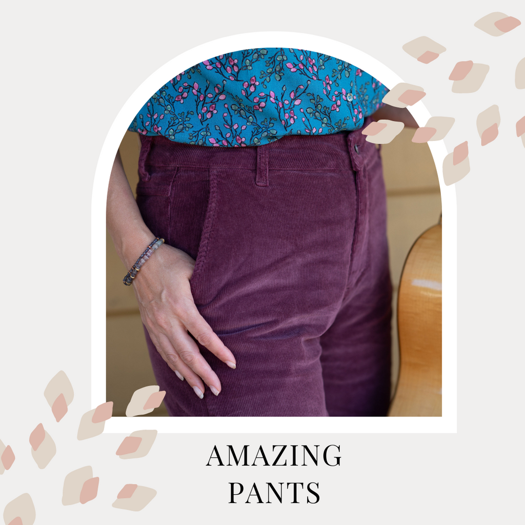 Text reads: Amazing pants. Dayna wears plum coloured cords, and one hand is in the pocket. She wears a blue printed blouse and holds a guitar.