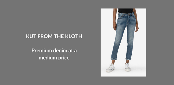 A woman's lower body is shown. She's wearing pair of jeans in a vintage medium wash and white sneakers. Text Reads: Kut From The Kloth: Premium denim at a medium price