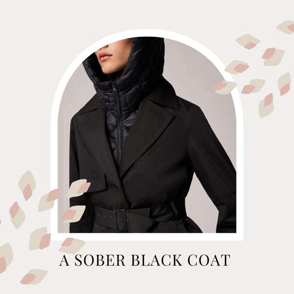A woman wears a black coat with a hood and looks off to one side. The coat is belted. Text reads: A sober black coat.
