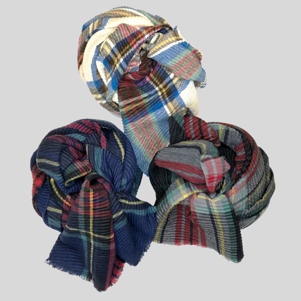 The image shows three plaid scarves rolled into cute balls.