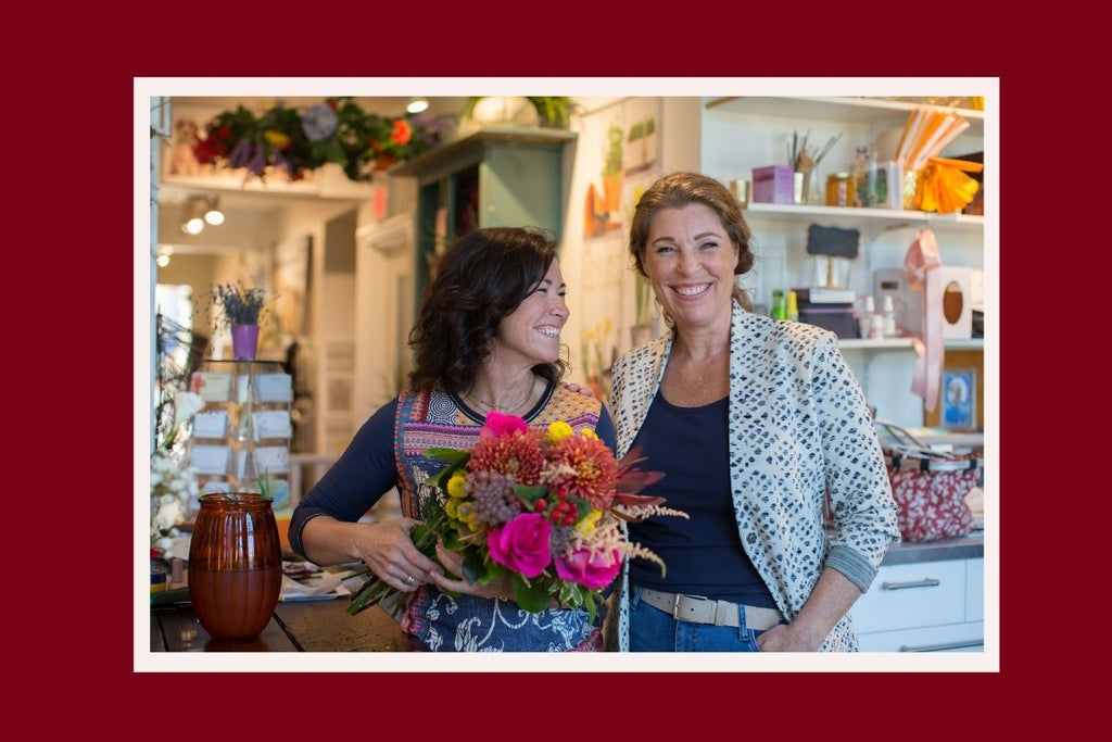 Cate Hishon and Resonance founder Jo Gordon smile together in Cate's Stratford floral shop, Designs By Cate.