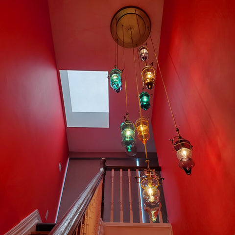 Painted red walls and blue and yellow glass blown light fixture.