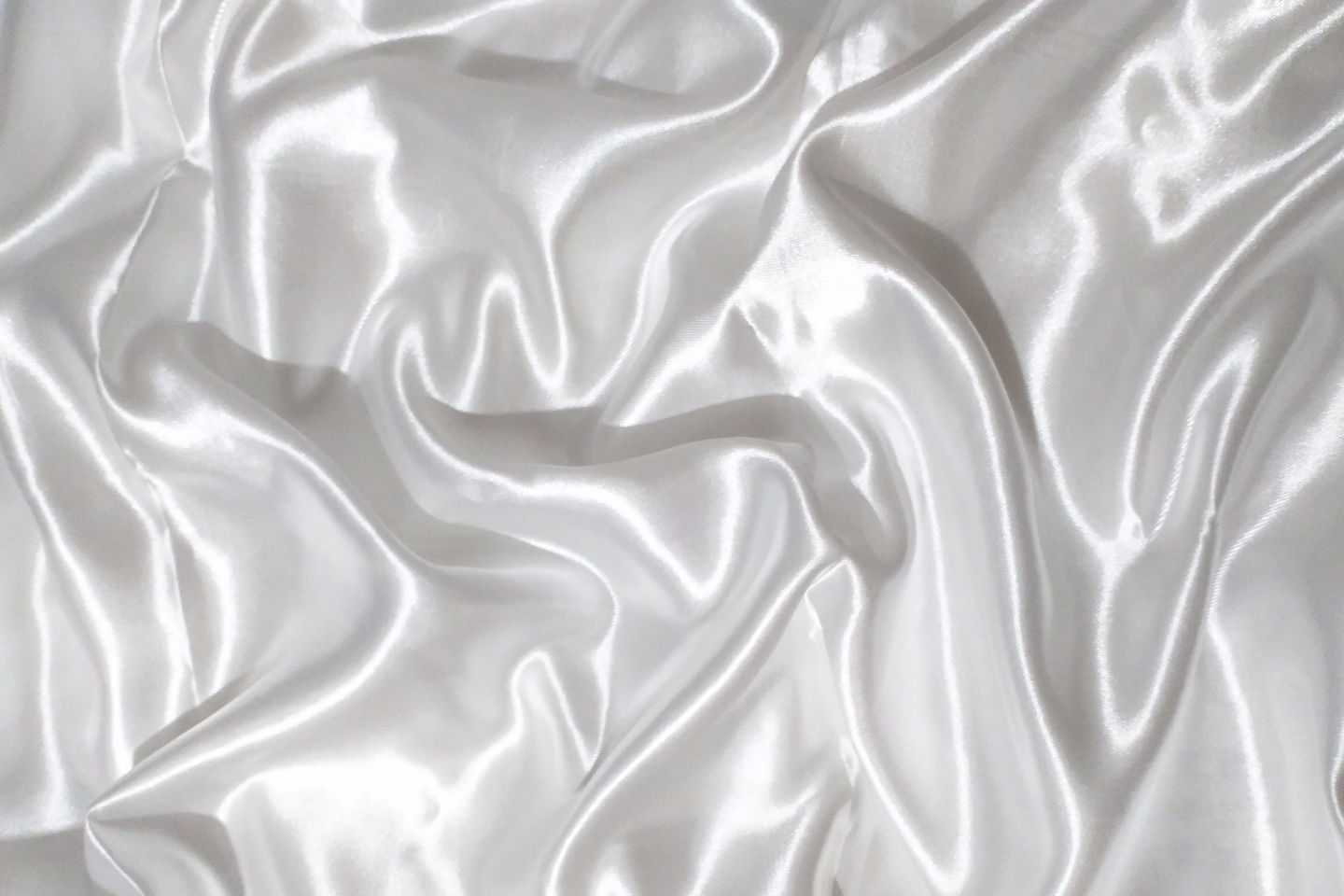 A soft, reflective white silk textile.