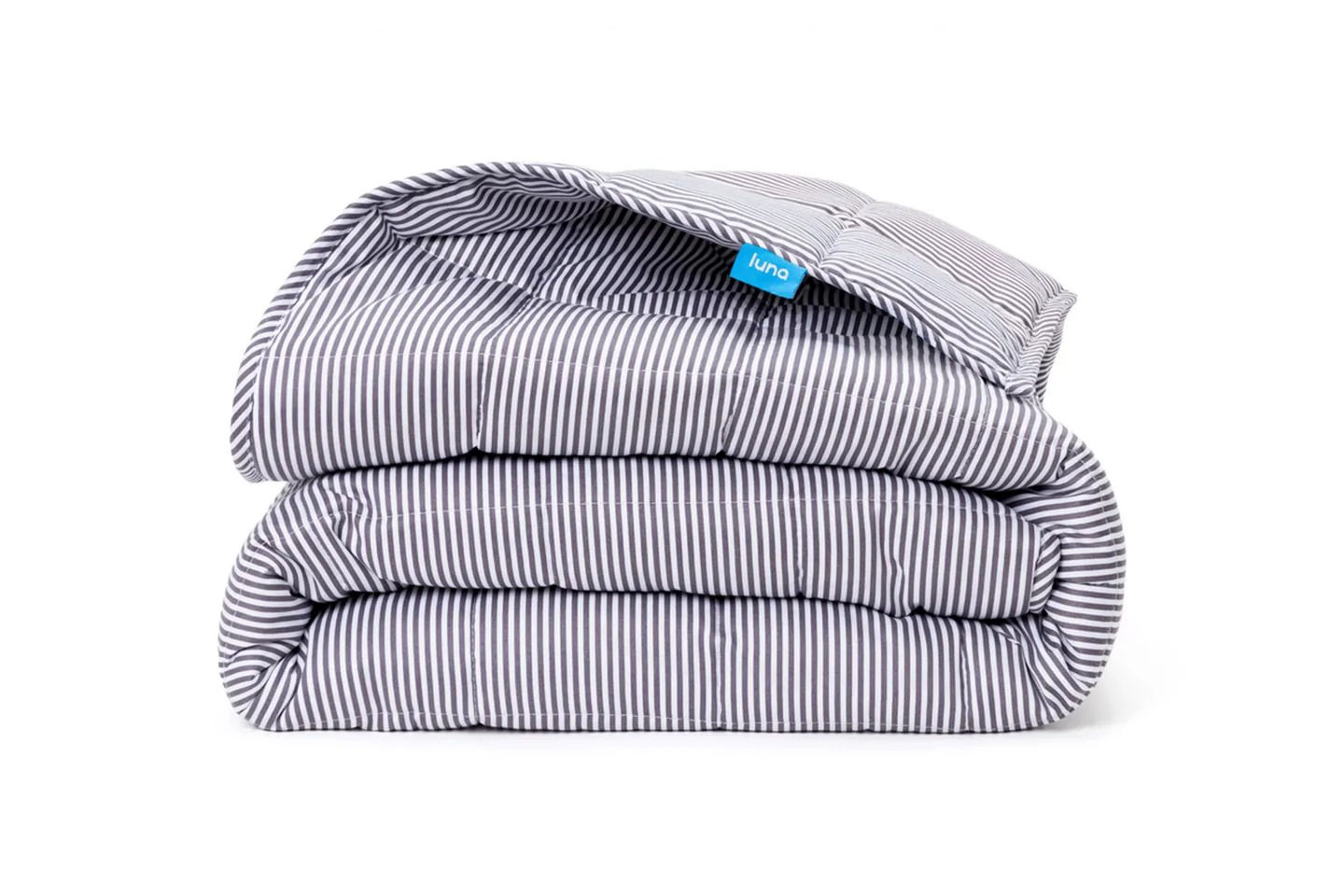 A folded grey and white striped Luna Cotton Weighted Blanket.