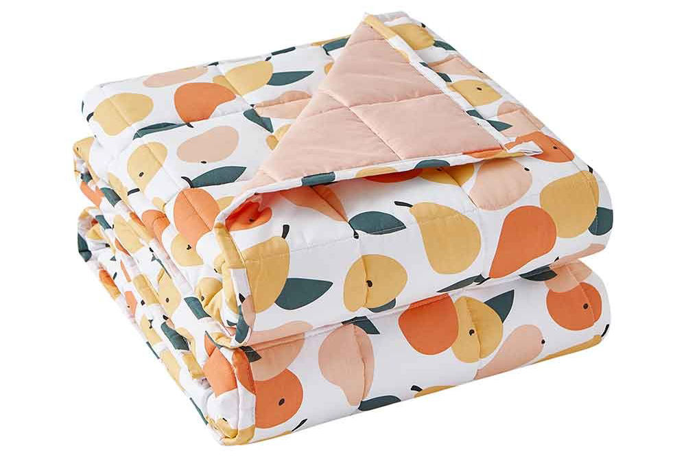 A neatly folded YNM Original Weighted Blanket in Peachy Keen color variant.