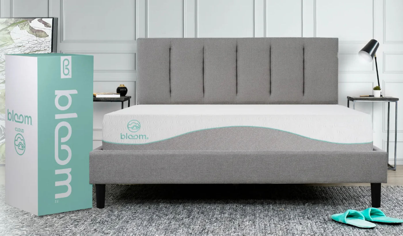 bloom mattress in grey bed frame with box packaging on the left