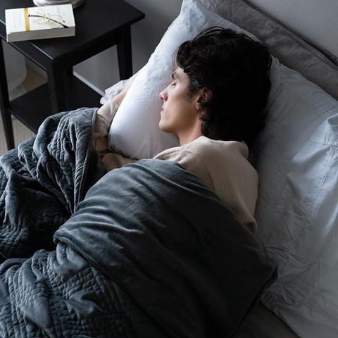 deep pressure therapy: Man sleeping in bed