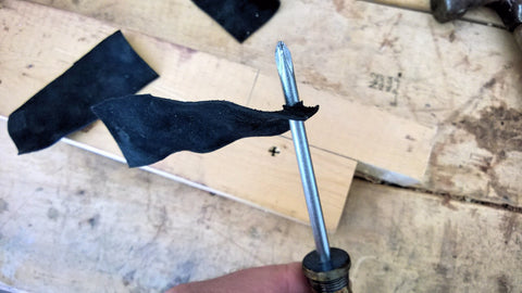 Pass the screwdriver through a few times to stretch the hole.