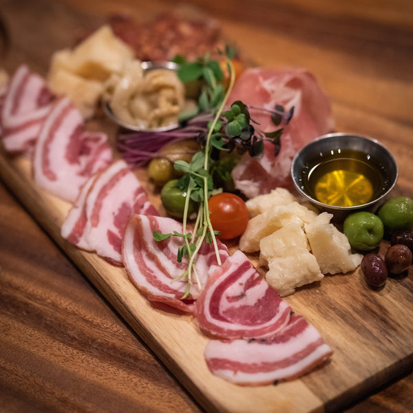 charcuterie board with meats and cheeses displayed