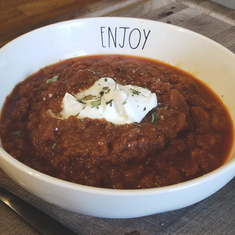 Bowl of soup topped with sour cream