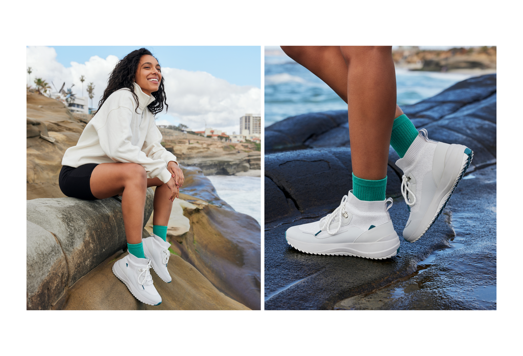 Female wearing Vessi Stormbursts in Frost White with teal crew socks, black biker shorts, and a cream quarter zip.