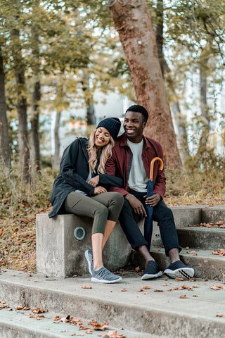 Man and woman sitting on a step enjoying the chilly weather.