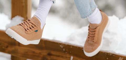 Woman wearing Vessi waterproof shoes out in the snow