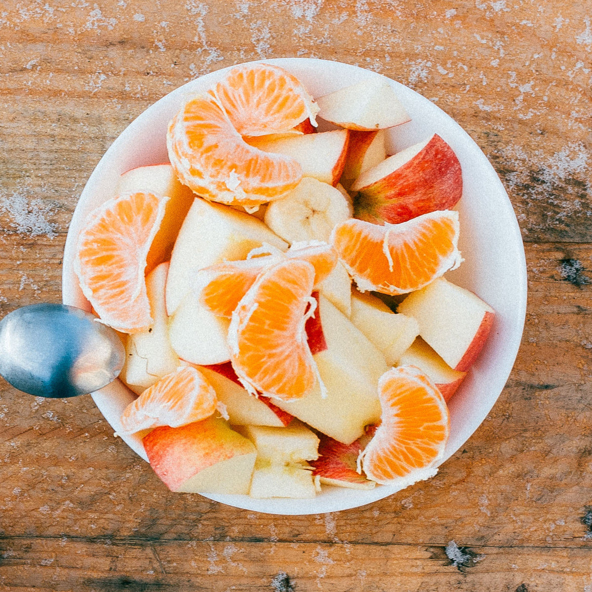 healthy snack bowl of cut-up apples and oranges