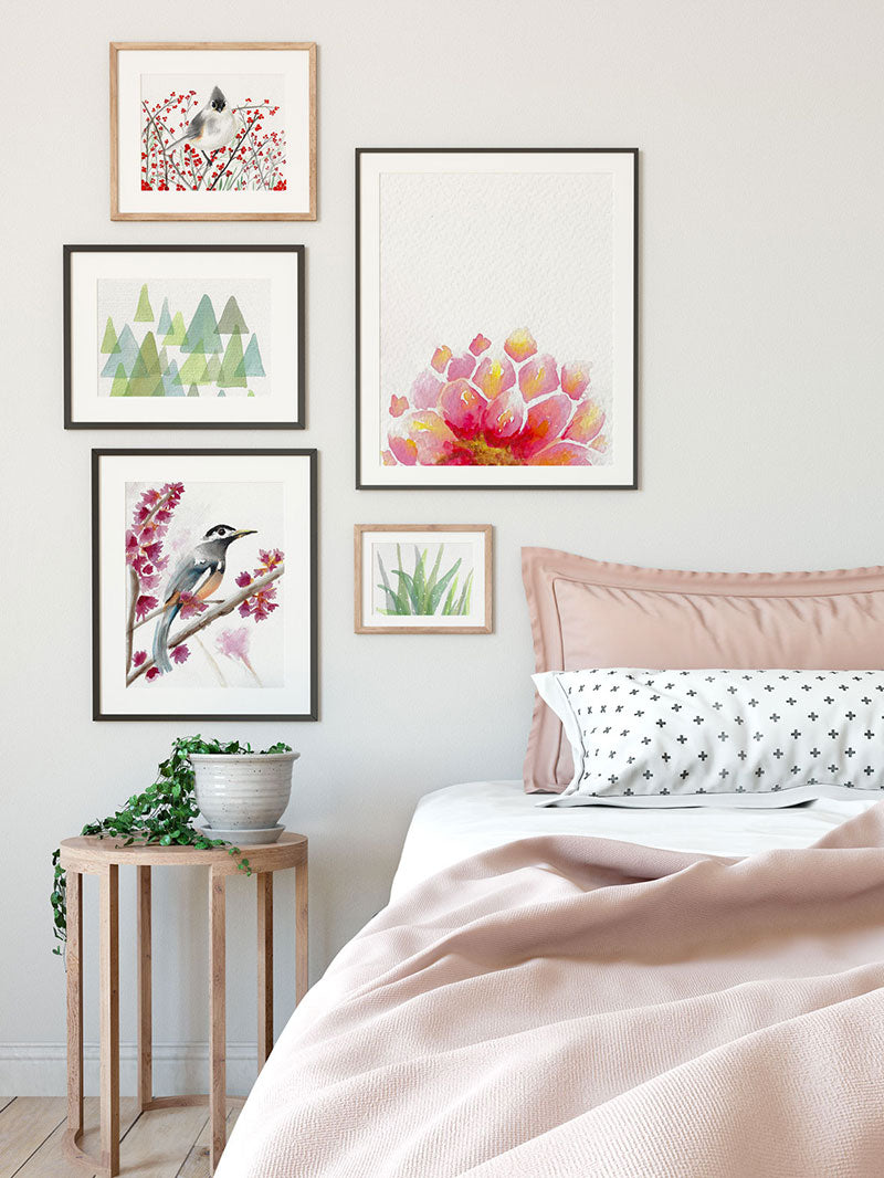 gallery wall of feminine pink watercolor prints hanging on bedroom wall - 7 ways art can improve your room decor