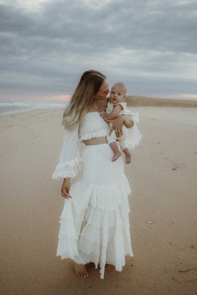 A beautiful non-pregnant lady wears Mama Rentals' The Boho Shed 'Wild Heart' Two Piece Set at her motherhood session.