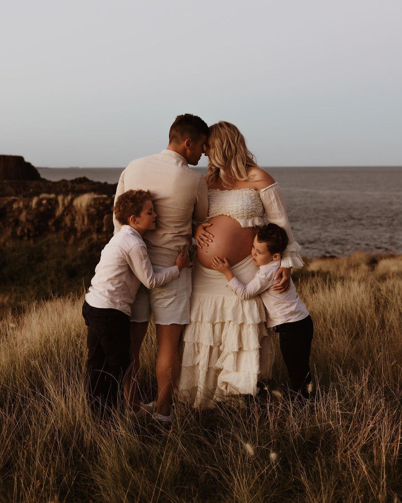 A beautiful pregnant lady wears Mama Rentals' The Boho Shed 'Wild Heart' Two Piece Set at her maternity session.