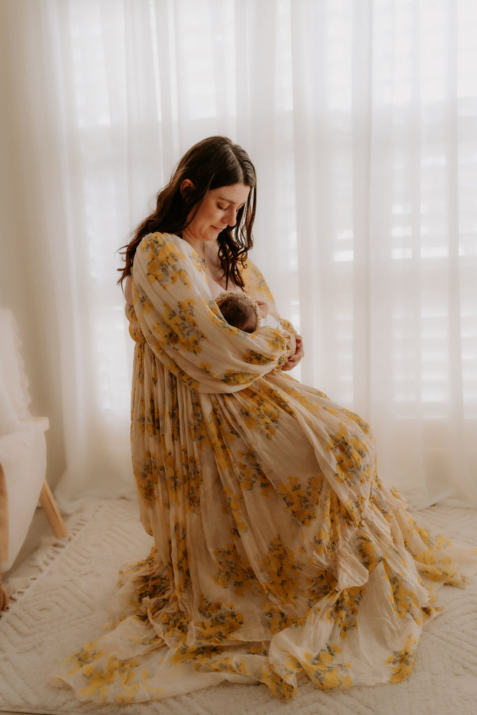 A beautiful non-pregnant lady wears Mama Rentals' Rooh Collective Poppy Zephyr Maxi Dress at her newborn photo shoot.