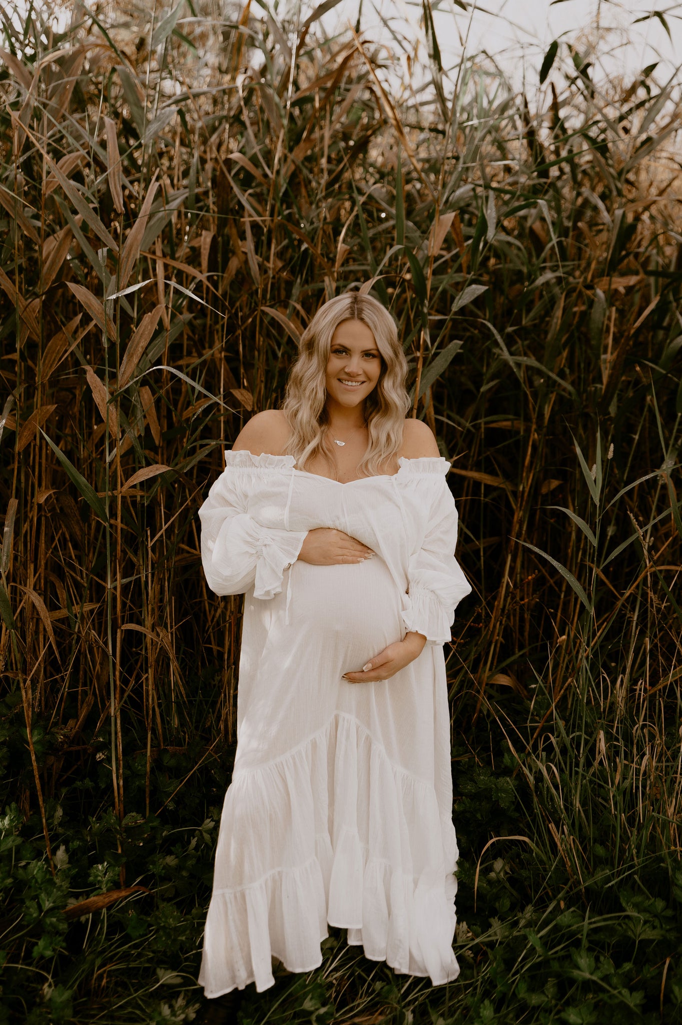 beautiful pregnant lady wearing the Hazel and Folk Emmaline gown in white