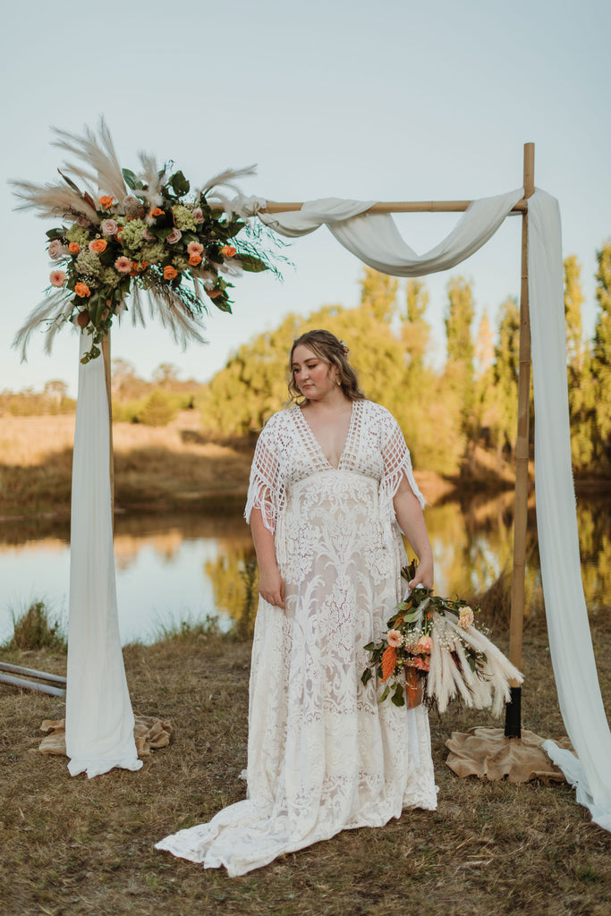 A beautiful non-pregnant lady wears Mama Rentals' Reclamation 'Bewitched by Boho' gown in Ivory colour at her elopement shoot.