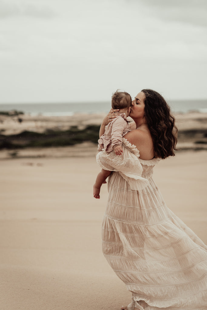 A beautiful non-pregnant lady wears Mama Rentals ReclamatiA beautiful non-pregnant lady wears Mama Rentals Reclamation Chiffon Delight gown in Beige at her family shoot.on Chiffon Delight gown in Beige at her photo shoot.