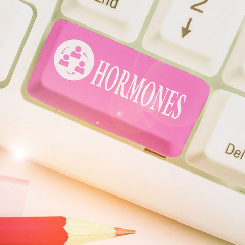 A computer keyboard with the shift key replaced by one that says hormones as a represenation of what causes menopause vaginal dryness. 